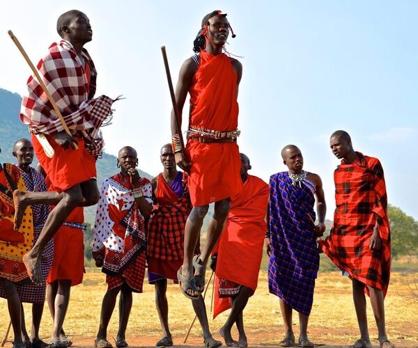 Maasai warriors performing traditional jumping dance during cultural visit in Kenya